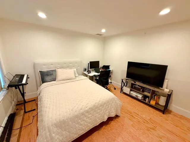 a bedroom with bed and tv on desk