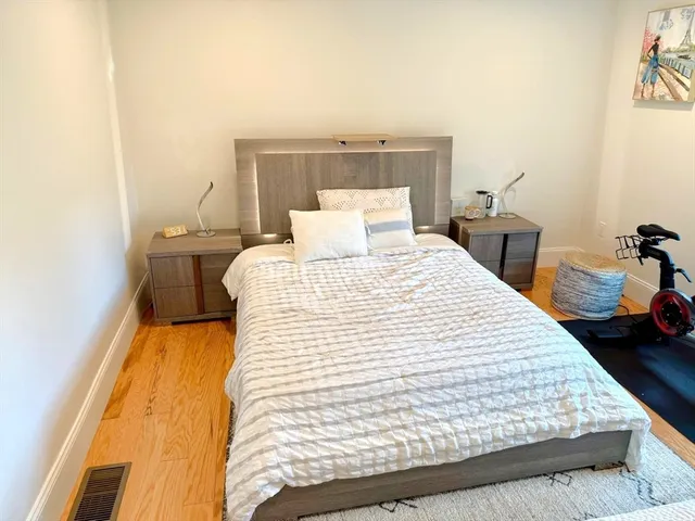 a large bed sitting in a bedroom next to a bathroom