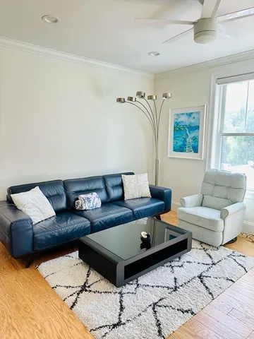 a living room with furniture and a rug