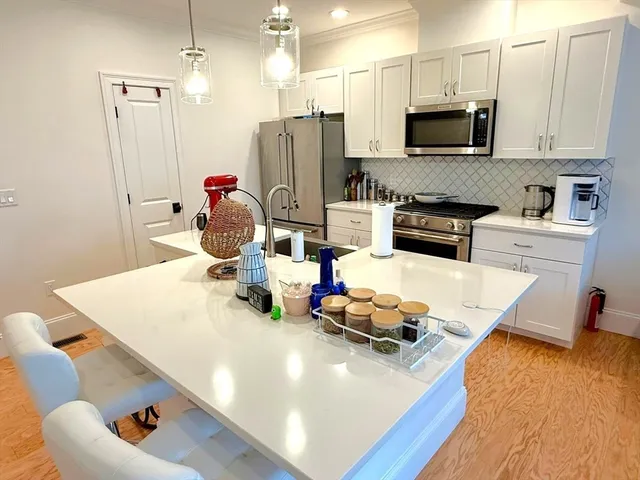 a kitchen with sink refrigerator and microwave