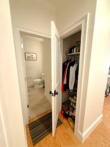a view of walk in closet with clothes and shoes