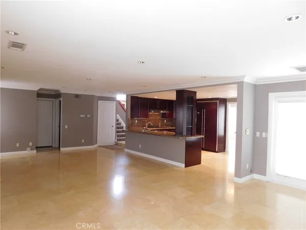 a view of a kitchen with a sink and a refrigerator