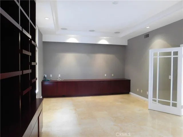 a view of an empty room with a fireplace and a window