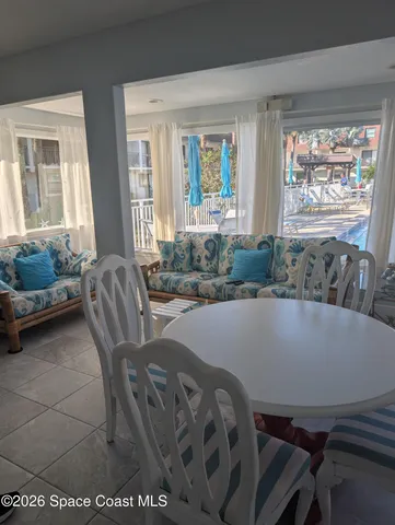 a view of a dining room with furniture and a large window