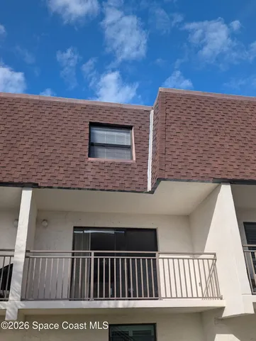 a view of a big room with wooden floor and windows