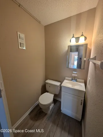 a kitchen with stainless steel appliances granite countertop a sink a stove and a wooden floors