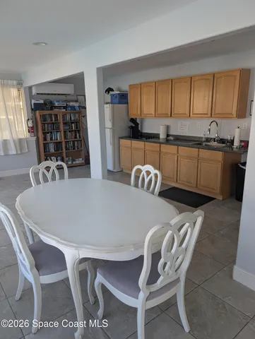 a dining room with furniture a window and kitchen view