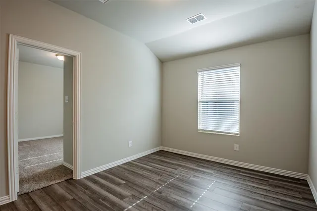 a view of a room with wooden floor and bathroom