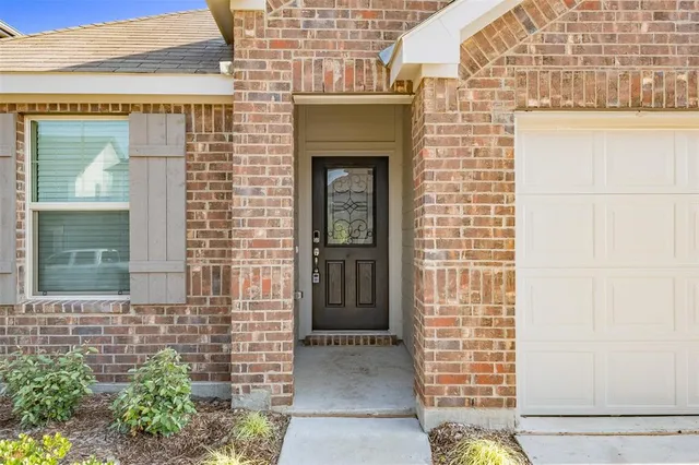 a front view of a house with a brick wall