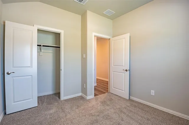 a view of an empty room with closet area