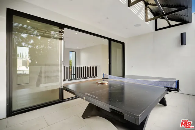 a room with pool table and windows
