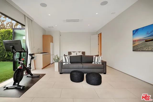 a living room with couch and a floor to ceiling window