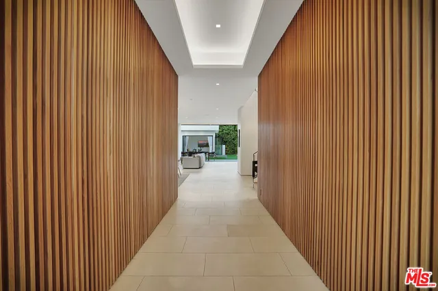 a view of a hallway with wooden fence
