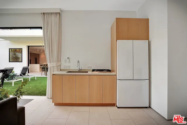 a kitchen with stainless steel appliances granite countertop a refrigerator and a stove