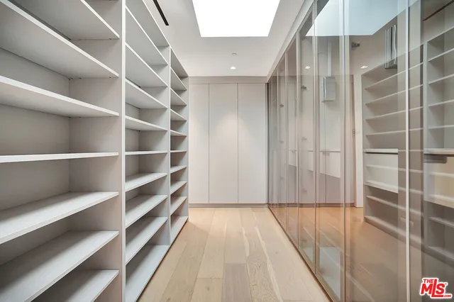 a view of walk in closet with empty racks
