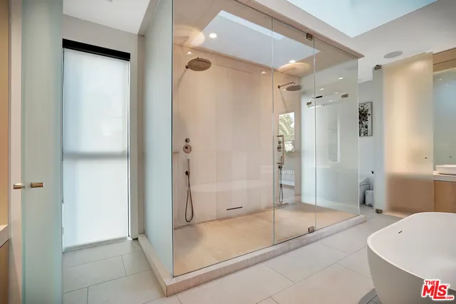 a bathroom with a tub shower and sink