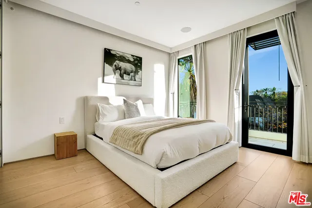 a bedroom with a large bed and a large window