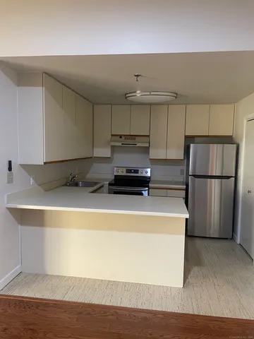 a kitchen with a refrigerator and a stove