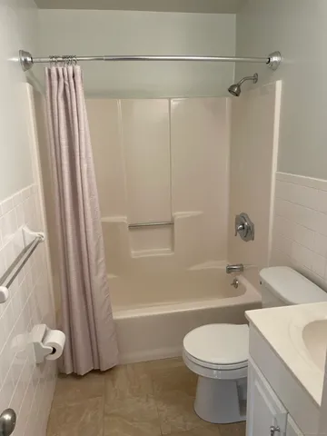 a bathroom with a toilet and a bathtub