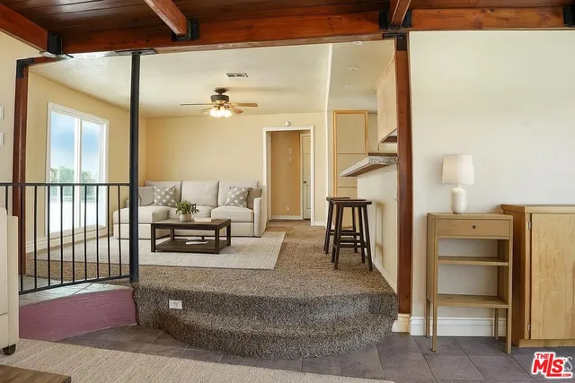 a living room with fireplace furniture and a window