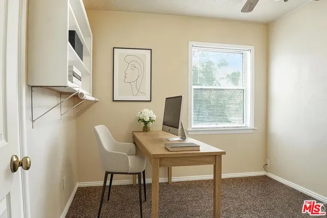 a view of a workspace with furniture
