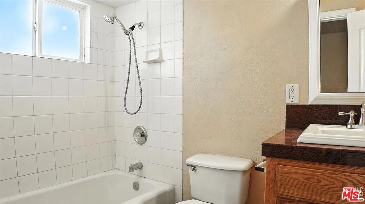 10931 Shellabarger Road Bakersfield, CA 93312 - Photo 24 of 44 a bathroom with a granite countertop bathtub sink vanity and toilet