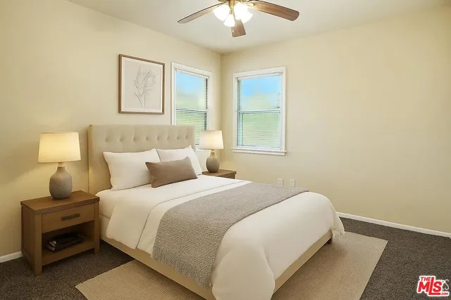 a bedroom with a bed and a lamp