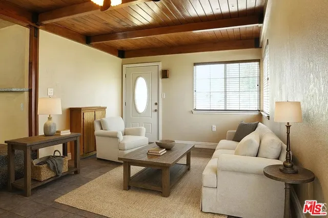 a living room with furniture and a lamp