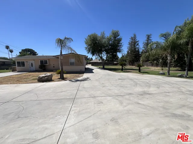 a view of a yard with potted plants