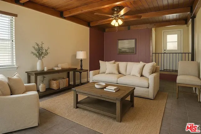 a living room with furniture and a ceiling fan