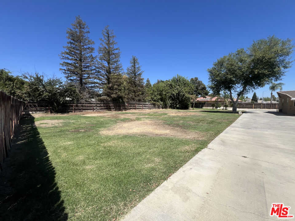 10931 Shellabarger Road Bakersfield, CA 93312 - Photo 42 of 44 a view of a swimming pool with a yard