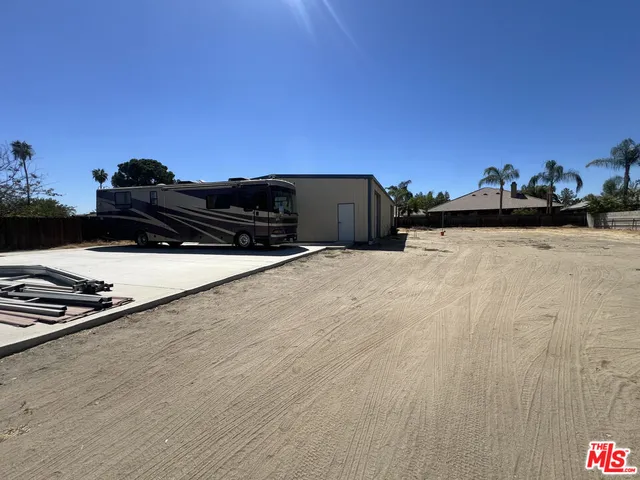 a view of backyard of house with green space