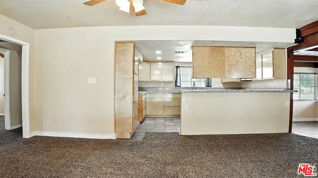 a kitchen with stainless steel appliances granite countertop a sink and a refrigerator