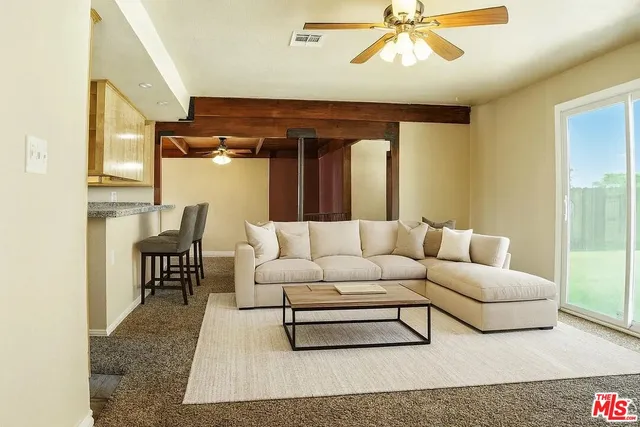 a living room with furniture and a rug