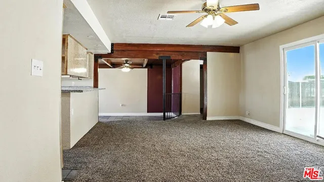 an empty room with closet and windows