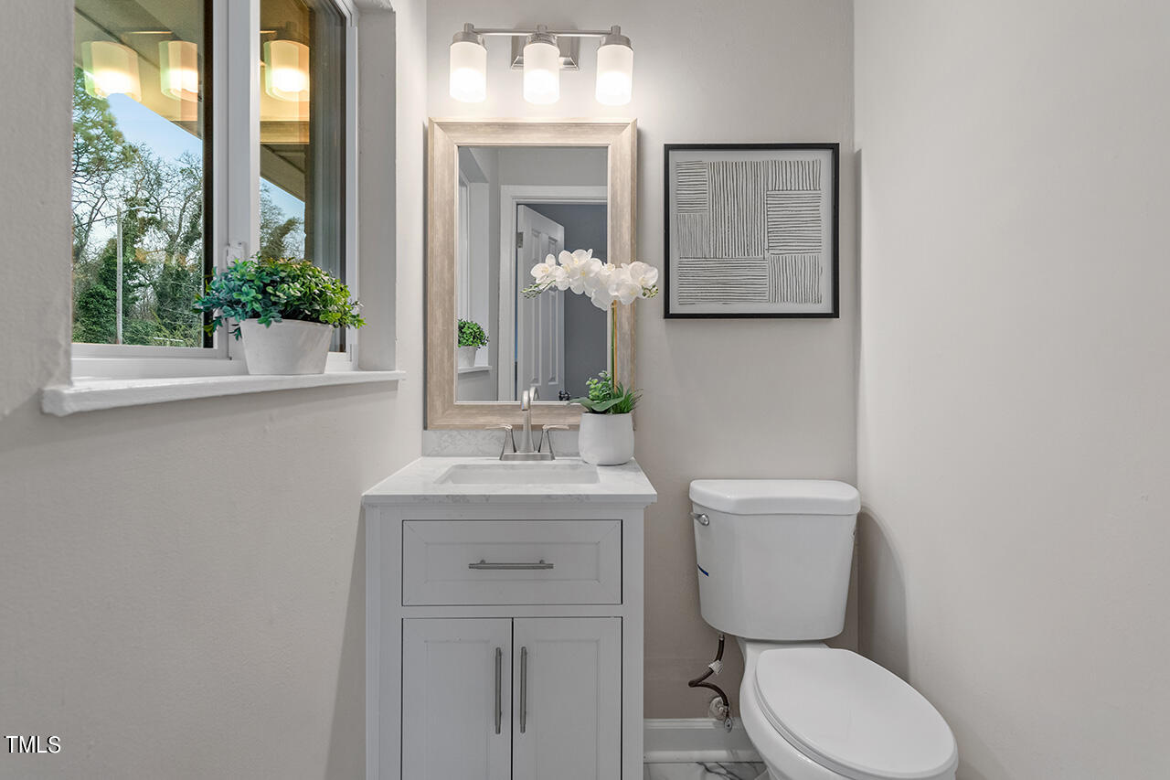 1610 Crescent Drive Spring Lake, NC 28390 - Photo 13 of 21 a bathroom with a toilet sink and mirror