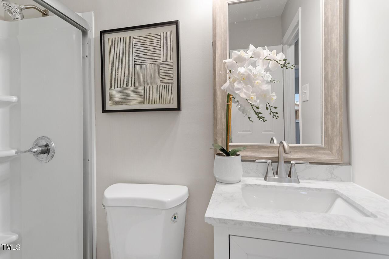 1610 Crescent Drive Spring Lake, NC 28390 - Photo 18 of 21 a bathroom with a sink a toilet and shower