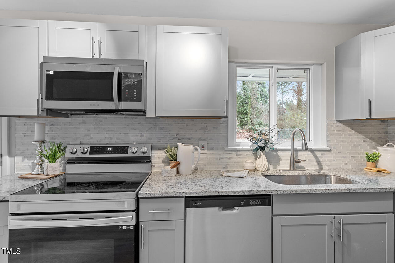 1610 Crescent Drive Spring Lake, NC 28390 - Photo 4 of 21 a kitchen with a sink stove and microwave