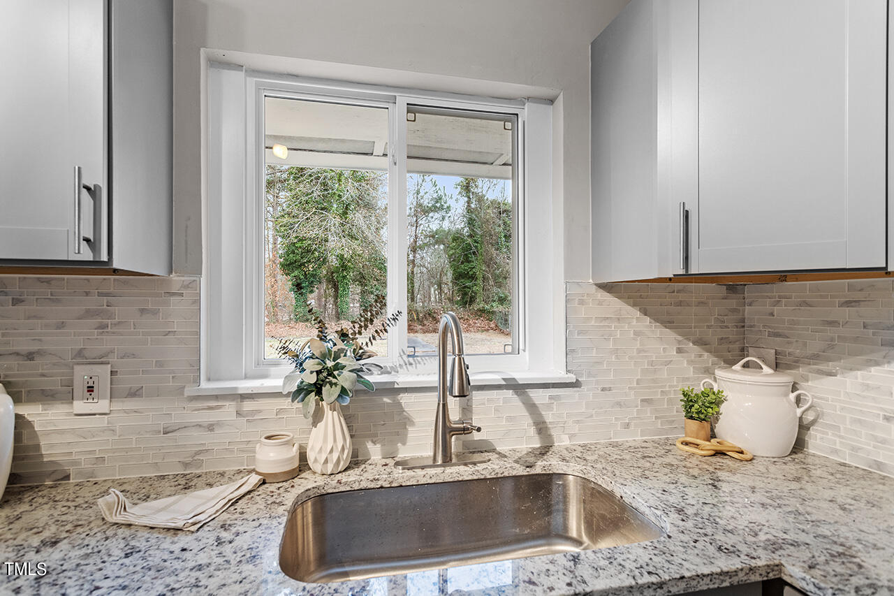 1610 Crescent Drive Spring Lake, NC 28390 - Photo 5 of 21 a kitchen with granite countertop a sink and a window