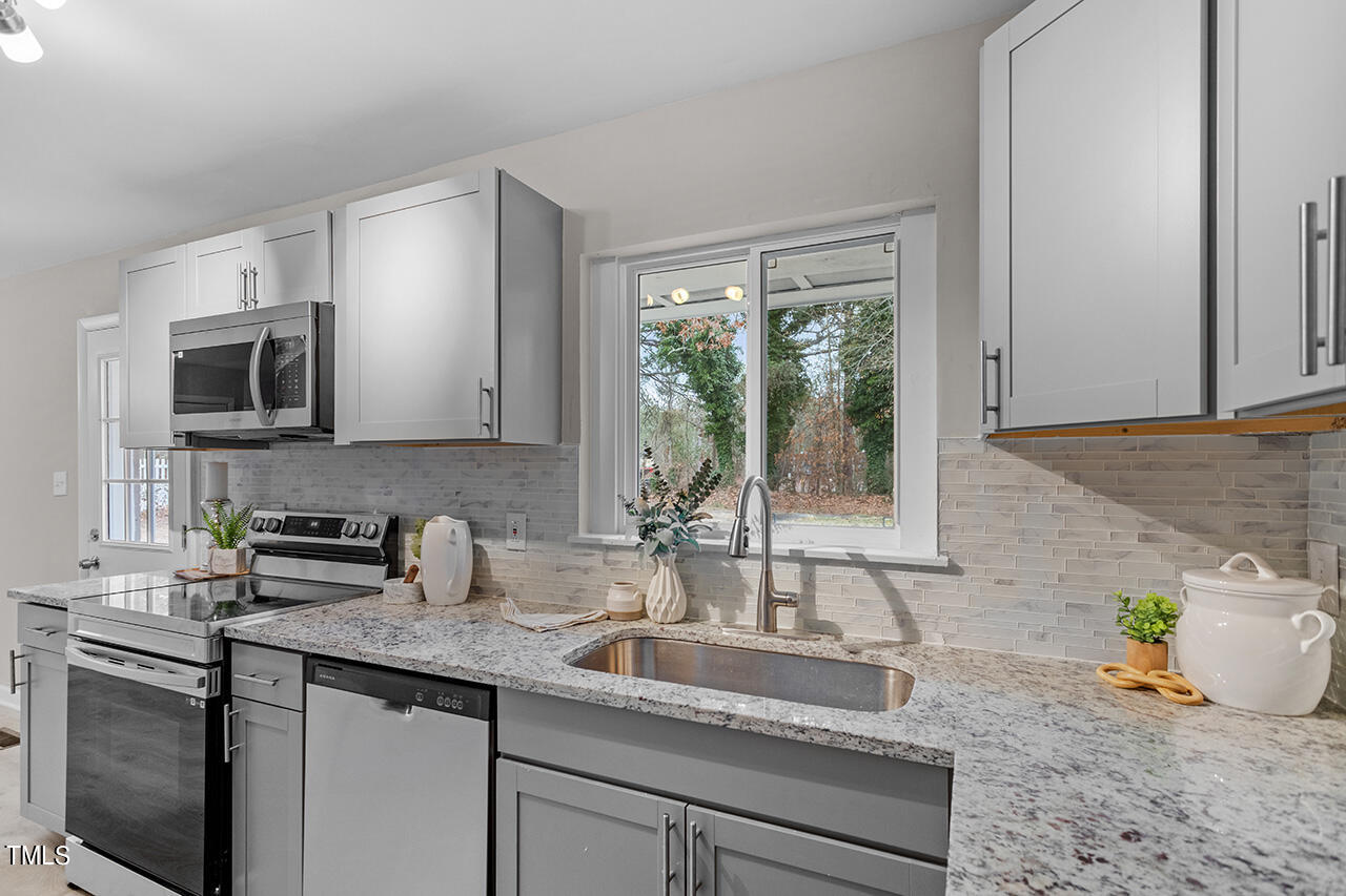 1610 Crescent Drive Spring Lake, NC 28390 - Photo 6 of 21 a kitchen with sink a microwave and cabinets
