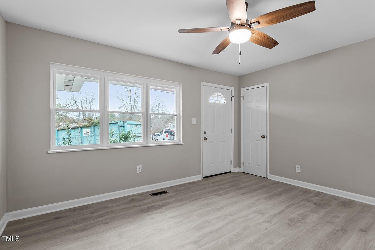 1610 Crescent Drive Spring Lake, NC 28390 - Photo 7 of 21 a view of an empty room with window and chandelier fan