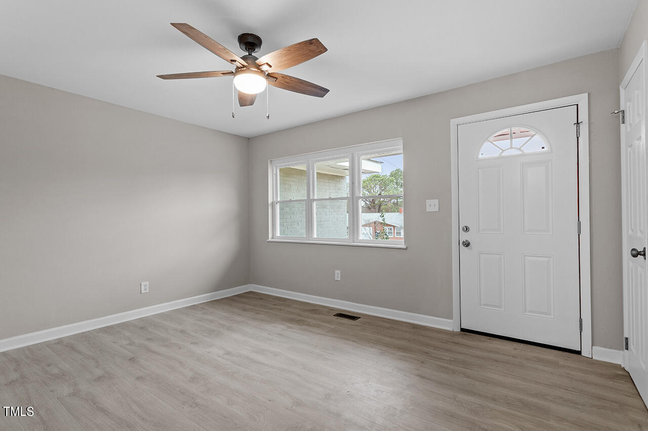 1610 Crescent Drive Spring Lake, NC 28390 - Photo 8 of 21 wooden floor in an empty room with a window