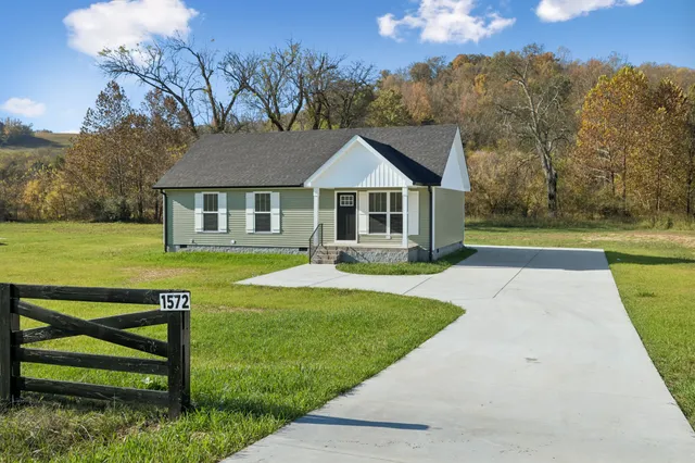 a front view of a house with a yard table and chairs