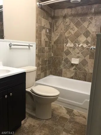 a bathroom with a toilet a sink and bathtub