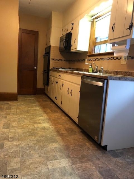 32 West Maple Avenue Bound Brook, NJ 08805 - Photo 8 of 12 a kitchen with stainless steel appliances granite countertop a sink and a stove