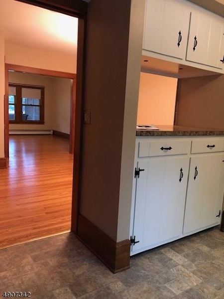 32 West Maple Avenue Bound Brook, NJ 08805 - Photo 9 of 12 a view of a kitchen with window and wooden floor