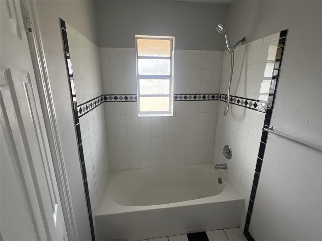 11558 Southeast 58th Avenue Belleview, FL 34420 - Photo 13 of 26 a bathroom with a bathtub and a shower