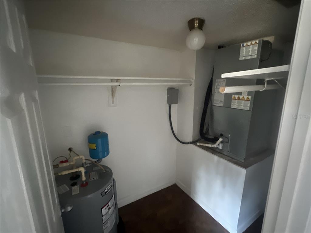 11558 Southeast 58th Avenue Belleview, FL 34420 - Photo 14 of 26 a room with water heater and storage