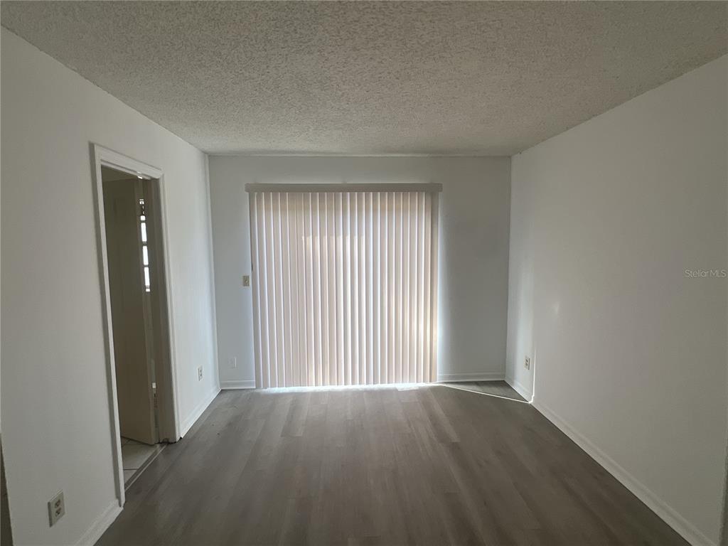 11558 Southeast 58th Avenue Belleview, FL 34420 - Photo 18 of 26 an empty room with wooden floor and windows