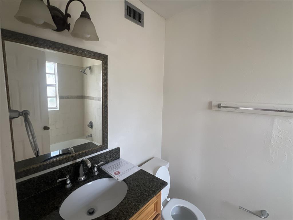 11558 Southeast 58th Avenue Belleview, FL 34420 - Photo 20 of 26 a bathroom with a sink vanity and a mirror